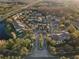 Aerial view of condo community with parking and landscaping, surrounded by natural greenery and a nearby highway at 17106 Carrington Park Dr # 627, Tampa, FL 33647