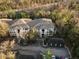Aerial view of condo building with parking and garages, nestled in a wooded area at 17106 Carrington Park Dr # 627, Tampa, FL 33647