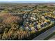 Panoramic aerial view of condo community surrounded by lush greenery near a tranquil lake at 17106 Carrington Park Dr # 627, Tampa, FL 33647