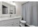 Bathroom features a white vanity with marble countertops and neutral-colored shower curtain at 17106 Carrington Park Dr # 627, Tampa, FL 33647