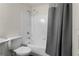 Bathroom featuring a white bathtub with a tiled wall and shower head at 17106 Carrington Park Dr # 627, Tampa, FL 33647