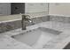 Close-up of the bathroom sink featuring marble countertops and modern fixtures at 17106 Carrington Park Dr # 627, Tampa, FL 33647