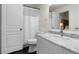 Bright bathroom with white vanity, marble countertop, and shower with white curtain at 17106 Carrington Park Dr # 627, Tampa, FL 33647