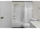 Clean bathroom featuring a white bathtub and toilet with a tiled wall at 17106 Carrington Park Dr # 627, Tampa, FL 33647