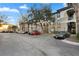 Exterior view of condo building with parking and garages, under a partly cloudy sky at 17106 Carrington Park Dr # 627, Tampa, FL 33647