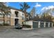 Exterior view of condo building and parking garages with palm trees and blue sky at 17106 Carrington Park Dr # 627, Tampa, FL 33647
