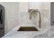 Close up of a modern kitchen sink, countertop, and backsplash at 17106 Carrington Park Dr # 627, Tampa, FL 33647