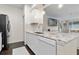 Modern kitchen featuring white cabinetry, marble countertops, and stainless steel appliances at 17106 Carrington Park Dr # 627, Tampa, FL 33647