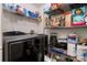 Pantry featuring wire shelving with dry foods and cleaning supplies next to washer and dryer at 17106 Carrington Park Dr # 627, Tampa, FL 33647