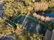 Aerial shot of tennis court surrounded by trees, near building and reflecting pond at 17106 Carrington Park Dr # 627, Tampa, FL 33647
