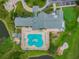 Overhead view of a clubhouse with a pool, set amidst lush green landscape and golf course at 10416 Moshie Ln, San Antonio, FL 33576