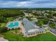 Aerial view of the clubhouse and pool area, surrounded by lush landscapes at 10416 Moshie Ln, San Antonio, FL 33576