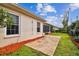 Well-kept backyard featuring a stone patio and mature landscaping, perfect for outdoor enjoyment and relaxation at 10416 Moshie Ln, San Antonio, FL 33576
