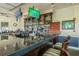 Inviting bar area with a granite countertop, wooden cabinets, and multiple TVs at 10416 Moshie Ln, San Antonio, FL 33576