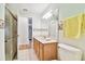 Bathroom with tile flooring, walk-in shower, light wood vanity and sink at 10416 Moshie Ln, San Antonio, FL 33576