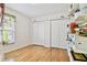 Bedroom with wood floors, window, and closet with bi-fold doors at 10416 Moshie Ln, San Antonio, FL 33576