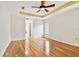An empty bedroom featuring a ceiling fan and wood floors and lots of light at 10416 Moshie Ln, San Antonio, FL 33576