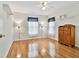 Bedroom boasts hardwood floors, and a vintage wood dresser between two windows at 10416 Moshie Ln, San Antonio, FL 33576