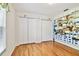 Bedroom with hardwood floors, bi-fold door closet, and open shelving at 10416 Moshie Ln, San Antonio, FL 33576