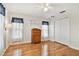 Bedroom features hardwood floors, an antique wooden dresser, and a double door closet at 10416 Moshie Ln, San Antonio, FL 33576