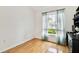 Bright bedroom with hardwood floors, a window, and a black cabinet at 10416 Moshie Ln, San Antonio, FL 33576