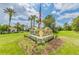 Entrance sign for Tampa Bay Golf & Country Club, featuring manicured landscaping and palm trees at 10416 Moshie Ln, San Antonio, FL 33576