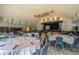 Bright event space featuring a stage, round tables, and ample lighting at 10416 Moshie Ln, San Antonio, FL 33576