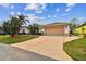 Attractive home featuring a wide driveway leading to an attached two-car garage and landscaping at 10416 Moshie Ln, San Antonio, FL 33576