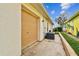 View of the house's exterior showing the garage, an external AC unit and a long driveway at 10416 Moshie Ln, San Antonio, FL 33576