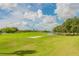 Scenic golf course view featuring a tranquil lake and neatly trimmed green, great for a day outdoors at 10416 Moshie Ln, San Antonio, FL 33576