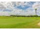 Expansive view of the meticulously maintained golf course, perfect for leisurely play at 10416 Moshie Ln, San Antonio, FL 33576