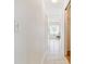 Bright hallway features tiled flooring and leads to a naturally lit room with a chair by the window at 10416 Moshie Ln, San Antonio, FL 33576