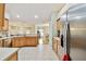 Spacious kitchen boasts ample counter space, stainless steel appliances, tile flooring, and easy access to the dining area at 10416 Moshie Ln, San Antonio, FL 33576