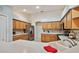 View of the kitchen featuring wood cabinets, a breakfast bar, stainless steel appliances, and a white sink at 10416 Moshie Ln, San Antonio, FL 33576