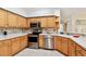 Well-maintained kitchen with stainless steel appliances, light wood cabinets, and ample counter space, perfect for cooking and entertaining at 10416 Moshie Ln, San Antonio, FL 33576