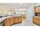 Open-concept kitchen with stainless steel dishwasher, plentiful counter space, and clear sightlines to adjacent living spaces at 10416 Moshie Ln, San Antonio, FL 33576