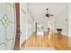 Bright living room with hardwood floors, ceiling fan, and sliding glass doors to the patio at 10416 Moshie Ln, San Antonio, FL 33576