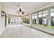 Spacious enclosed patio featuring a ceiling fan, numerous windows, and bright neutral color palette at 10416 Moshie Ln, San Antonio, FL 33576