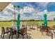 Relaxing outdoor patio with tables and chairs, perfect for enjoying the community golf course at 10416 Moshie Ln, San Antonio, FL 33576