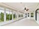 Enclosed patio with many windows and a ceiling fan, extending indoor living to the outdoors at 10416 Moshie Ln, San Antonio, FL 33576