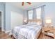 Cozy bedroom with natural light, two side tables, a ceiling fan, and ample closet space at 10639 Carloway Hills Dr, Wimauma, FL 33598