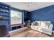 This charming bedroom is complete with built-in shelves and cabinets and a comfortable couch at 10639 Carloway Hills Dr, Wimauma, FL 33598