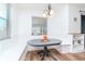 Bright breakfast nook features a built-in bench, a round table, and a window with natural light at 10639 Carloway Hills Dr, Wimauma, FL 33598