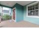 View of front porch showing the hardscape flooring and light blue exterior at 10639 Carloway Hills Dr, Wimauma, FL 33598