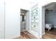 Hallway with built-in shelving leading to a bedroom and bathroom at 10639 Carloway Hills Dr, Wimauma, FL 33598