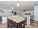 Open kitchen featuring granite countertops, a large island, stainless steel dishwasher, and pendant lighting at 10639 Carloway Hills Dr, Wimauma, FL 33598