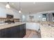 Spacious kitchen featuring granite countertops, stainless steel appliances, and a kitchen island at 10639 Carloway Hills Dr, Wimauma, FL 33598