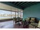 Enclosed lanai featuring comfortable seating, a view of the lake, and a screen enclosure at 10639 Carloway Hills Dr, Wimauma, FL 33598