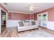 Cozy living room with a couch, built-in shelving, and access to a balcony at 10639 Carloway Hills Dr, Wimauma, FL 33598