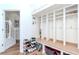 Organized mudroom with built-in cubbies, storage bench, and stylish decor at 10639 Carloway Hills Dr, Wimauma, FL 33598